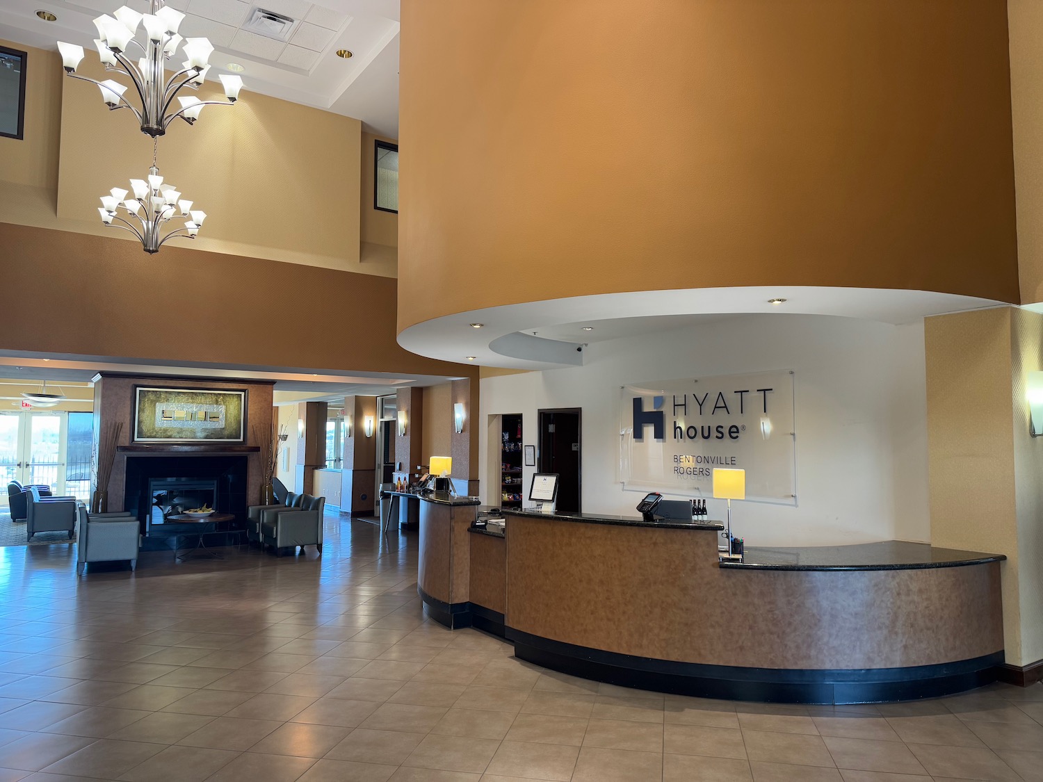 a lobby with a reception desk and a fireplace