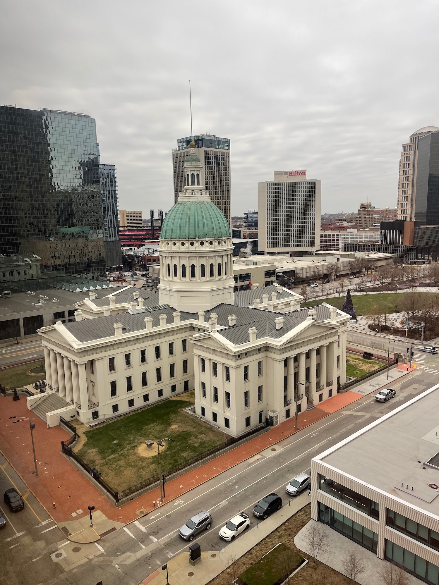 a large white building with a green dome on the top