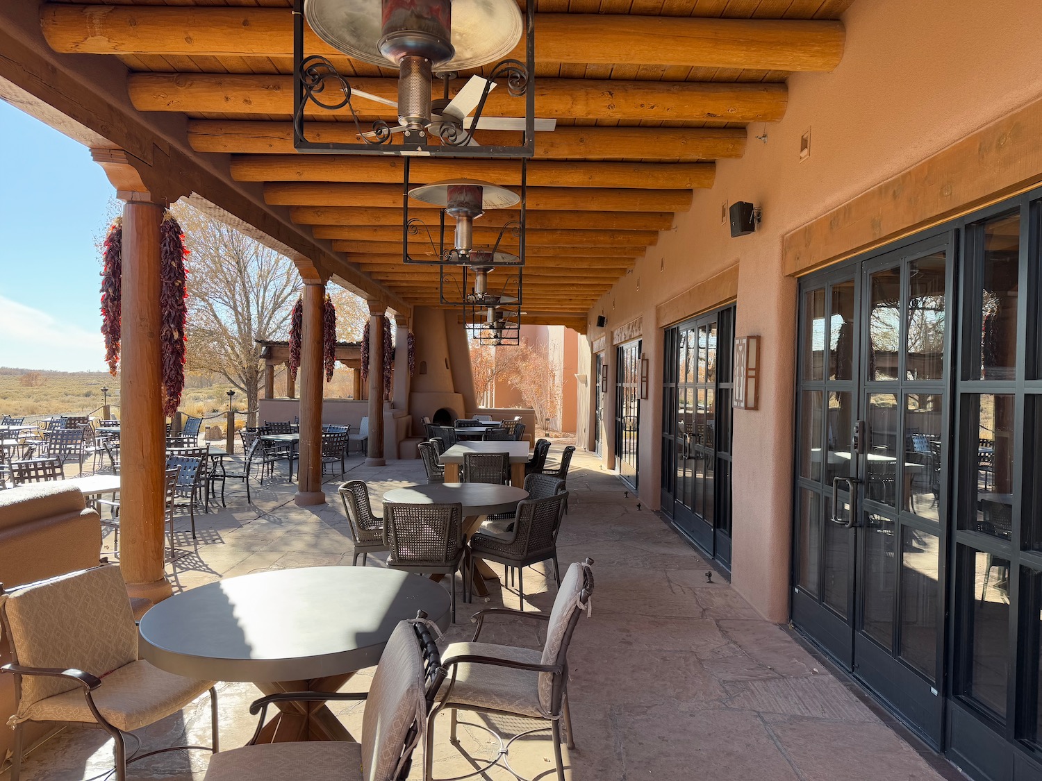 a patio with tables and chairs