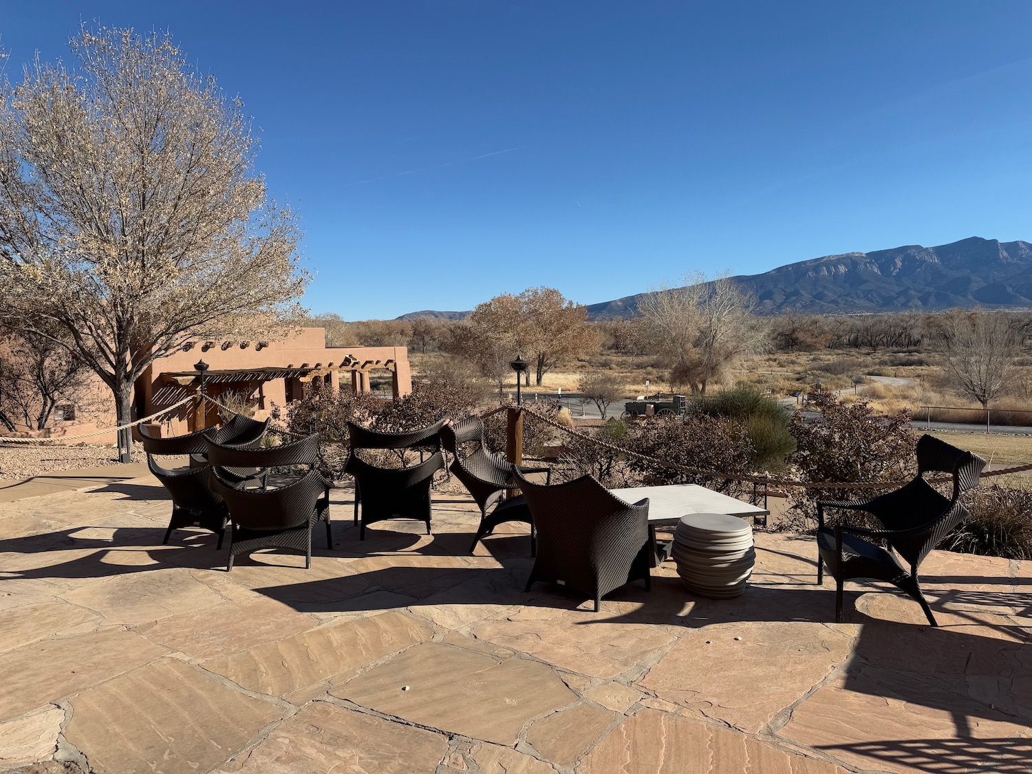 a patio with chairs and a table