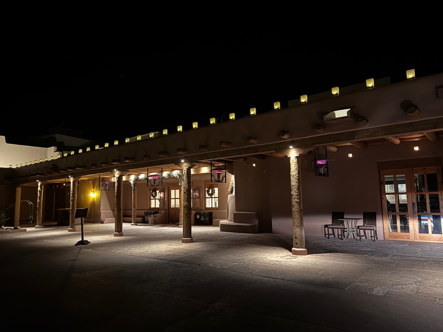 a building with pillars and lights at night