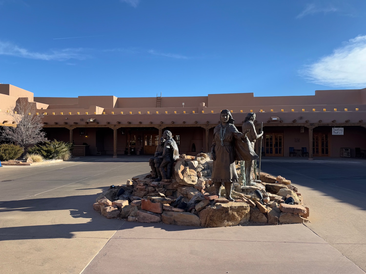 a statue of a group of people in front of a building