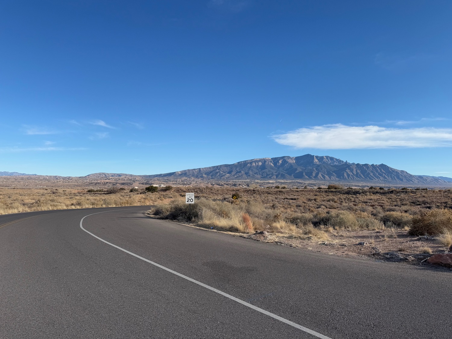 a road with a mountain in the background