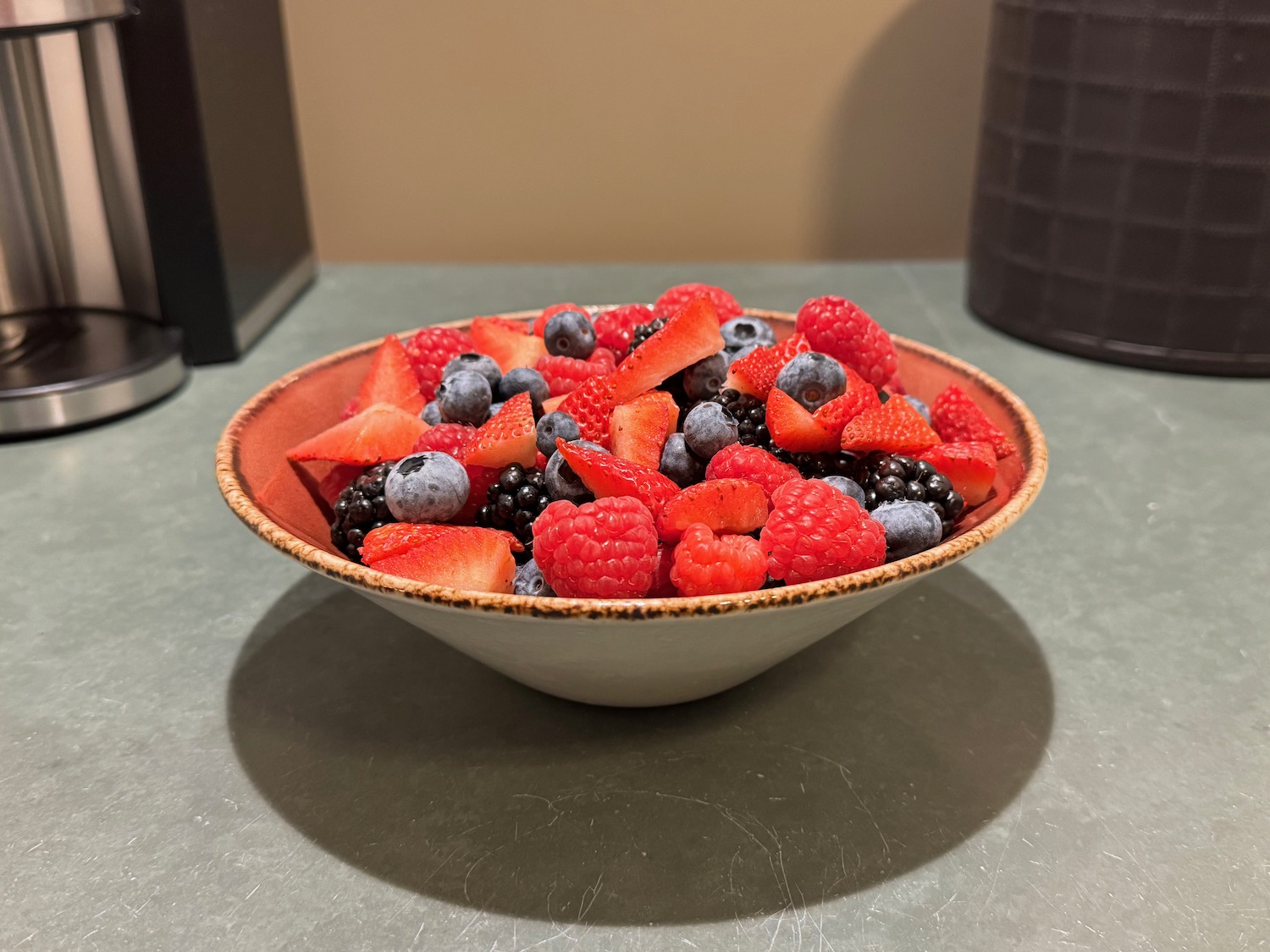 a bowl of fruit on a counter