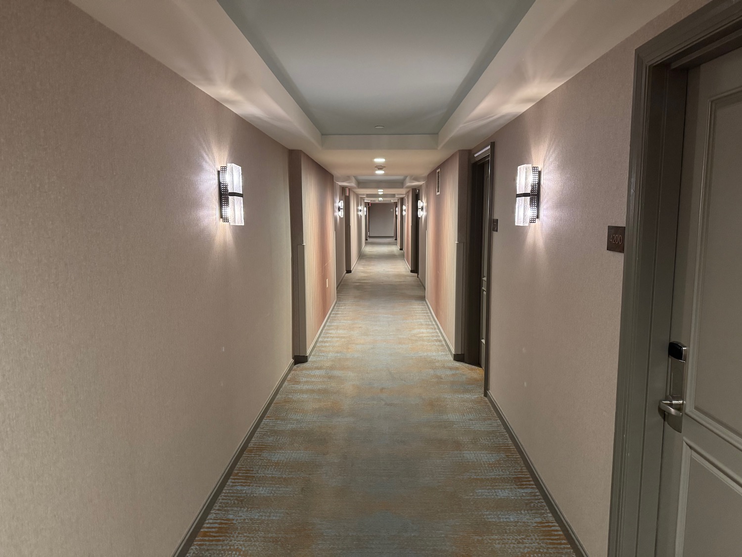 a hallway with lights on the wall