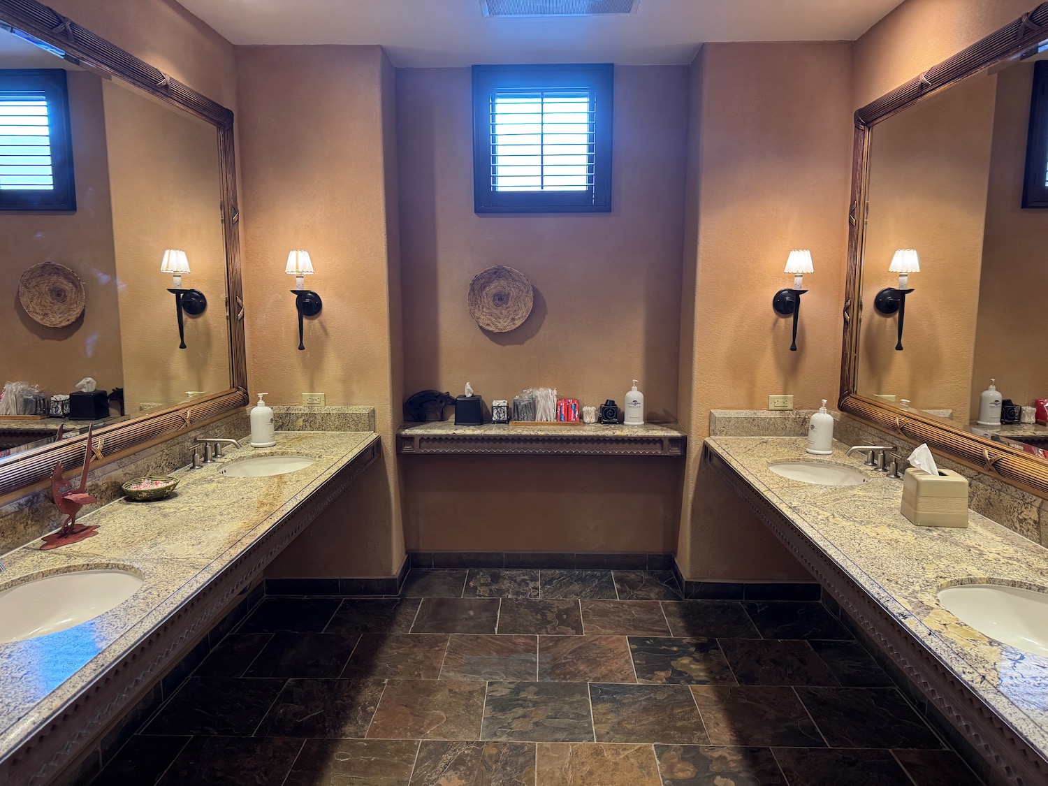 a bathroom with sinks and mirrors