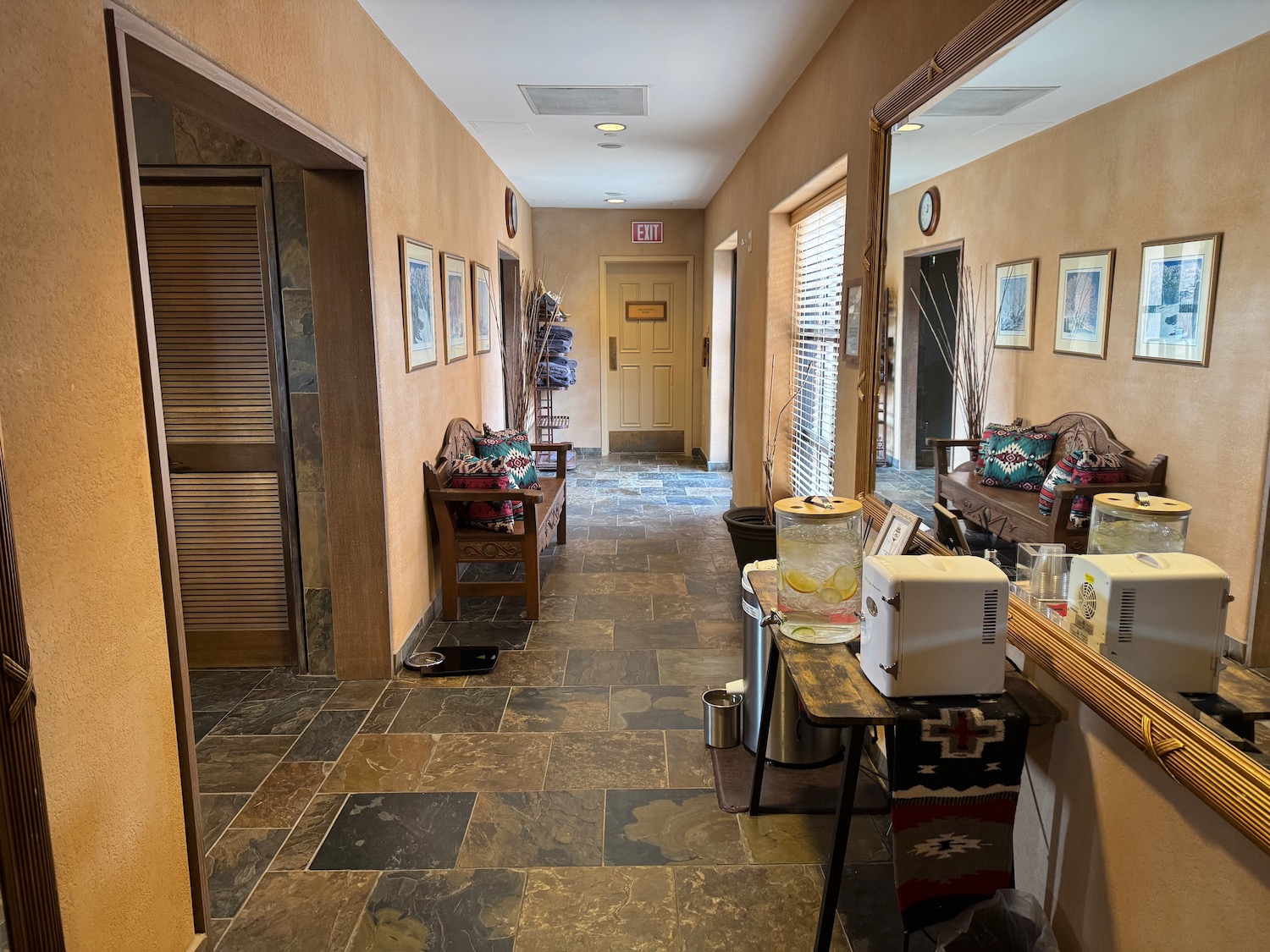 a hallway with a mirror and a table