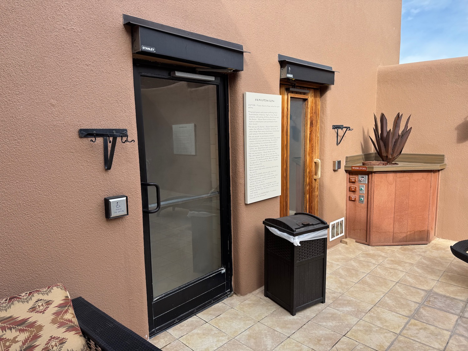 a door and a trash can outside of a building