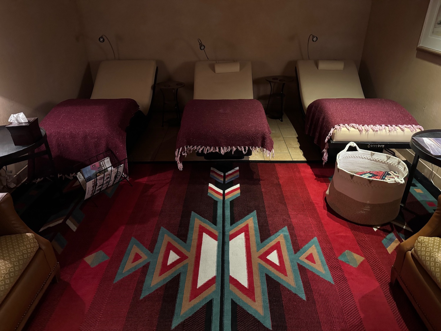 a room with beds and a rug