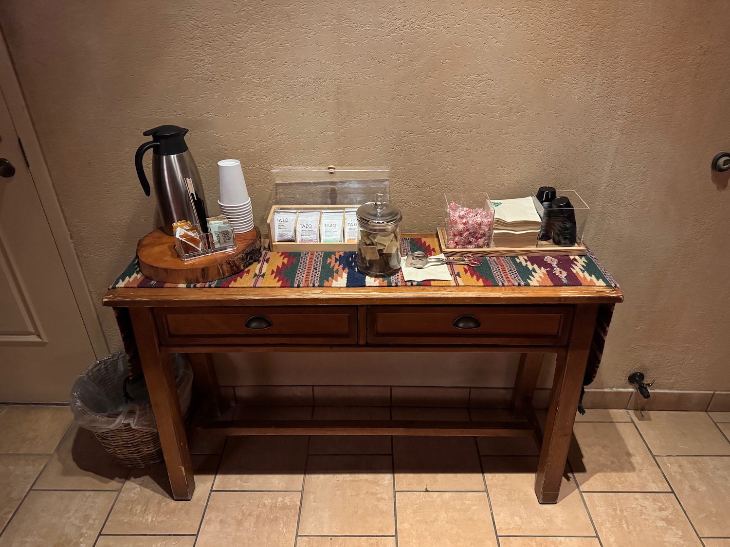 a table with a tray of coffee and candy