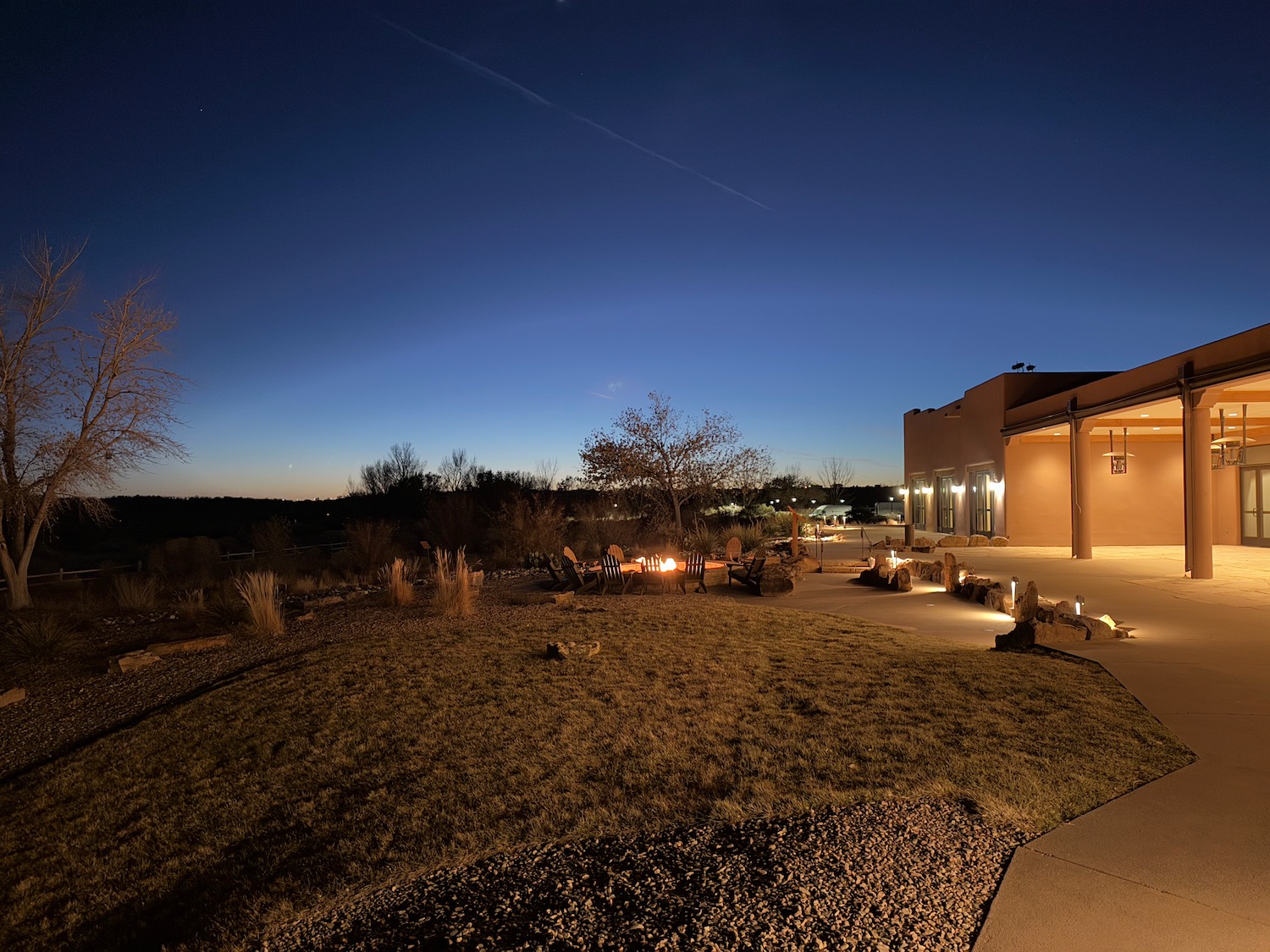 a building with a fire pit and a patio