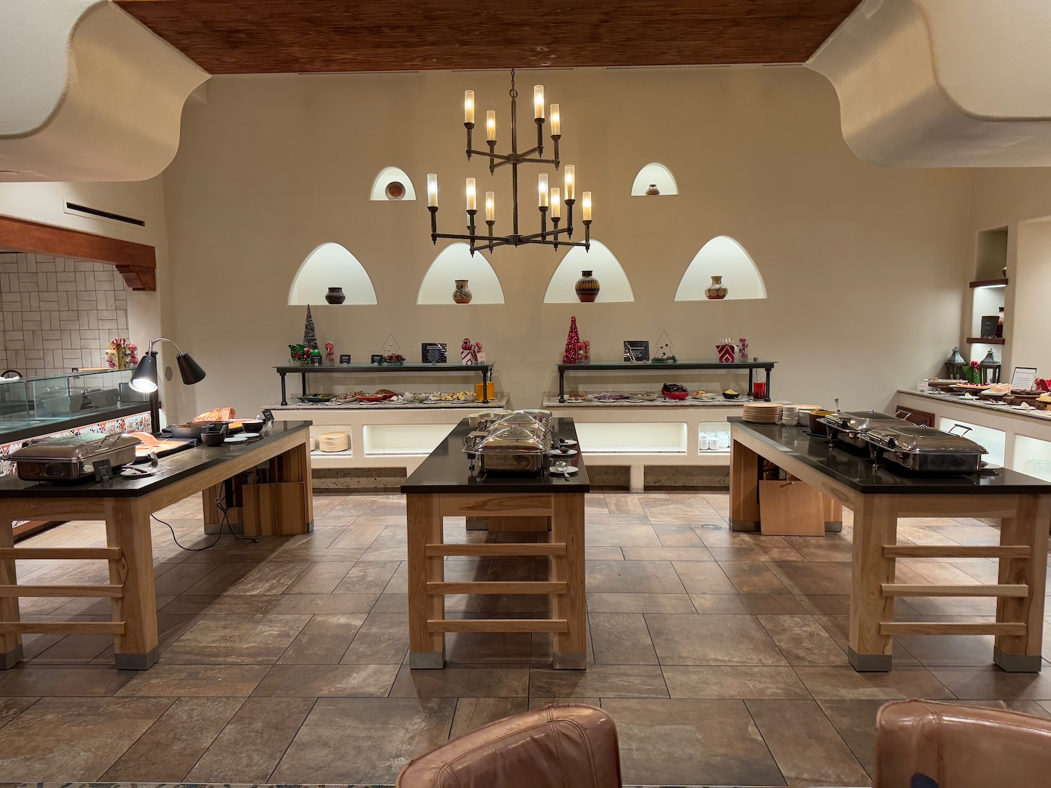 a large room with a buffet table and chairs