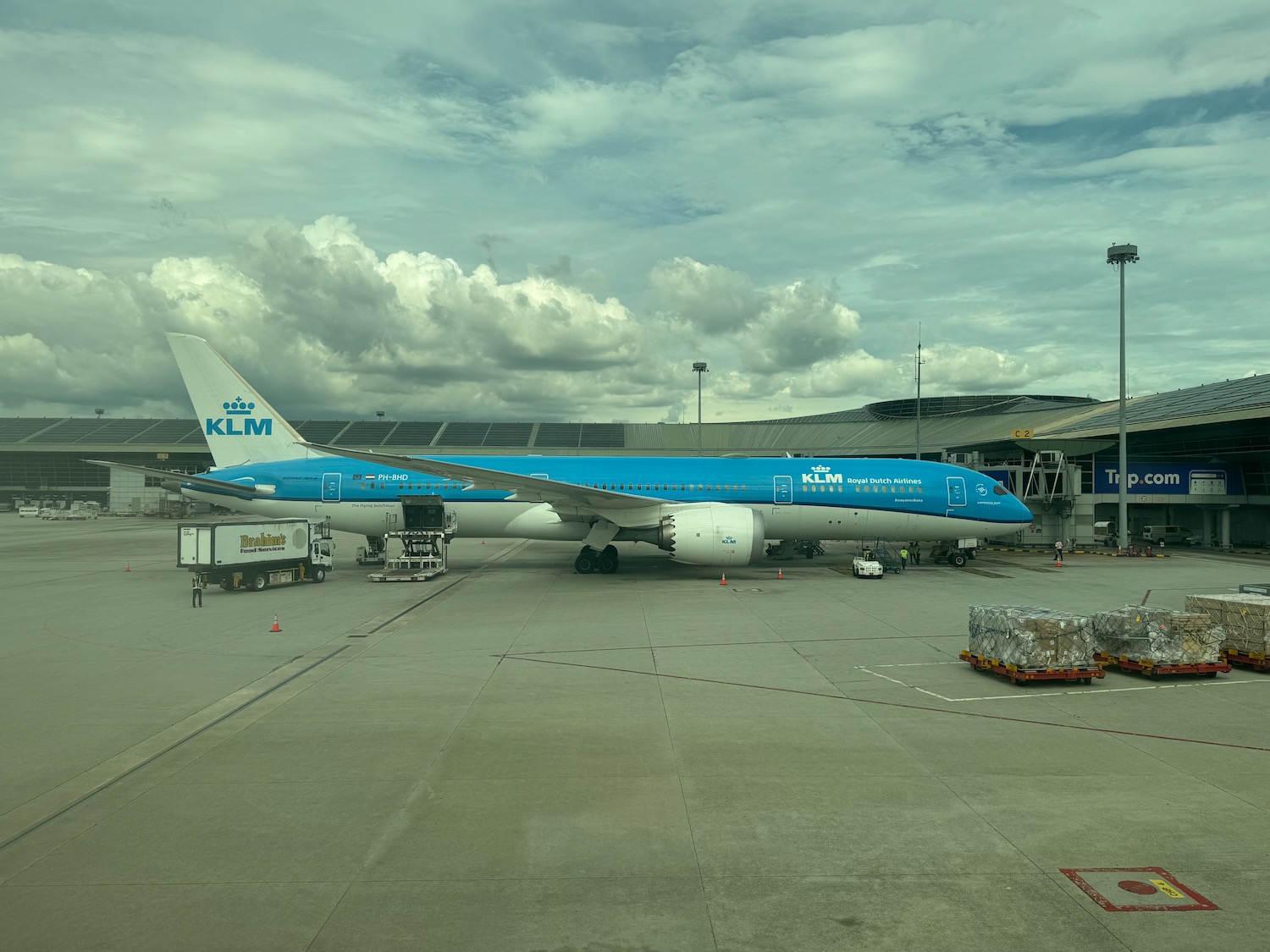 a blue and white airplane on a tarmac