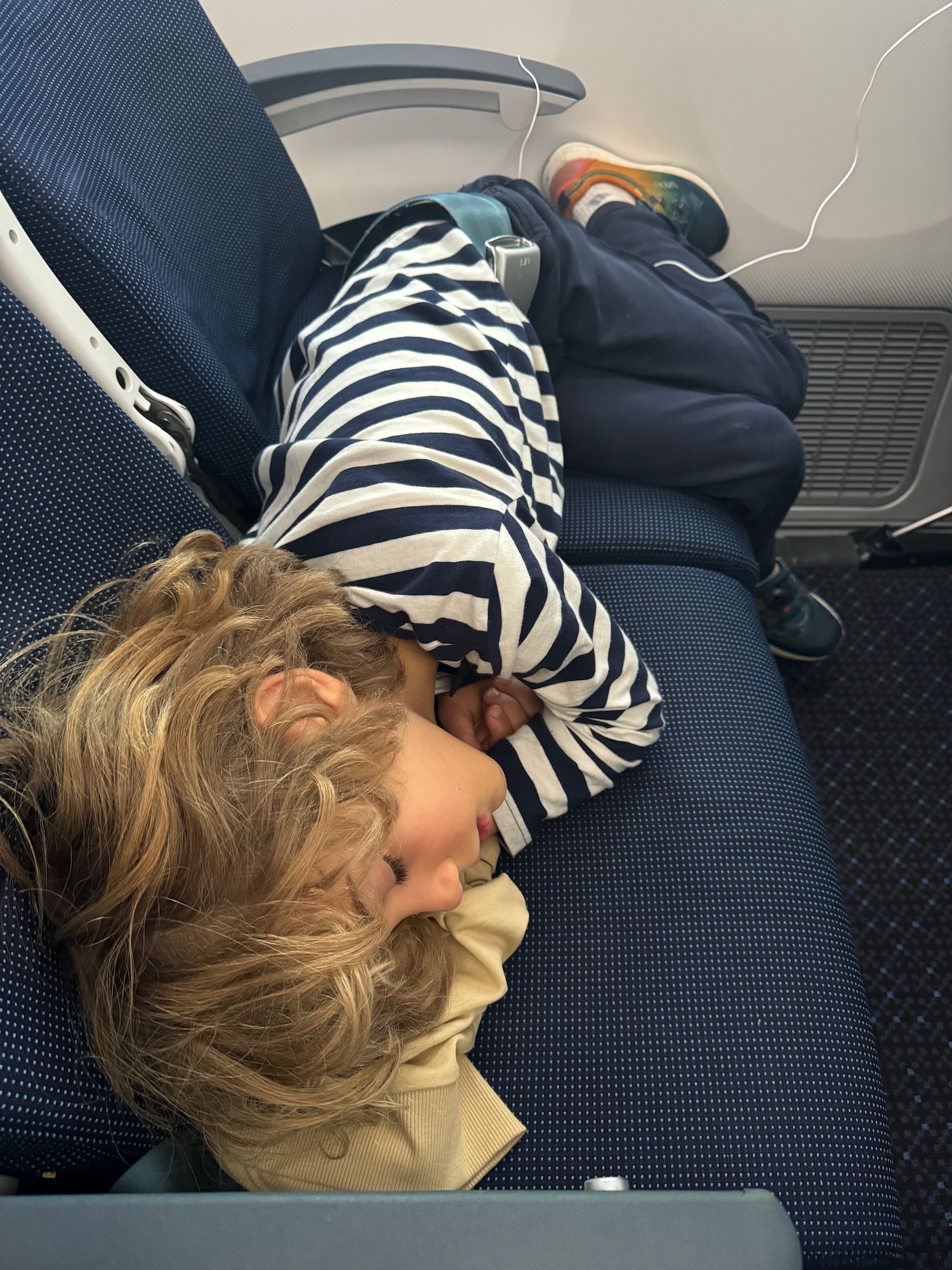 a child sleeping on a seat