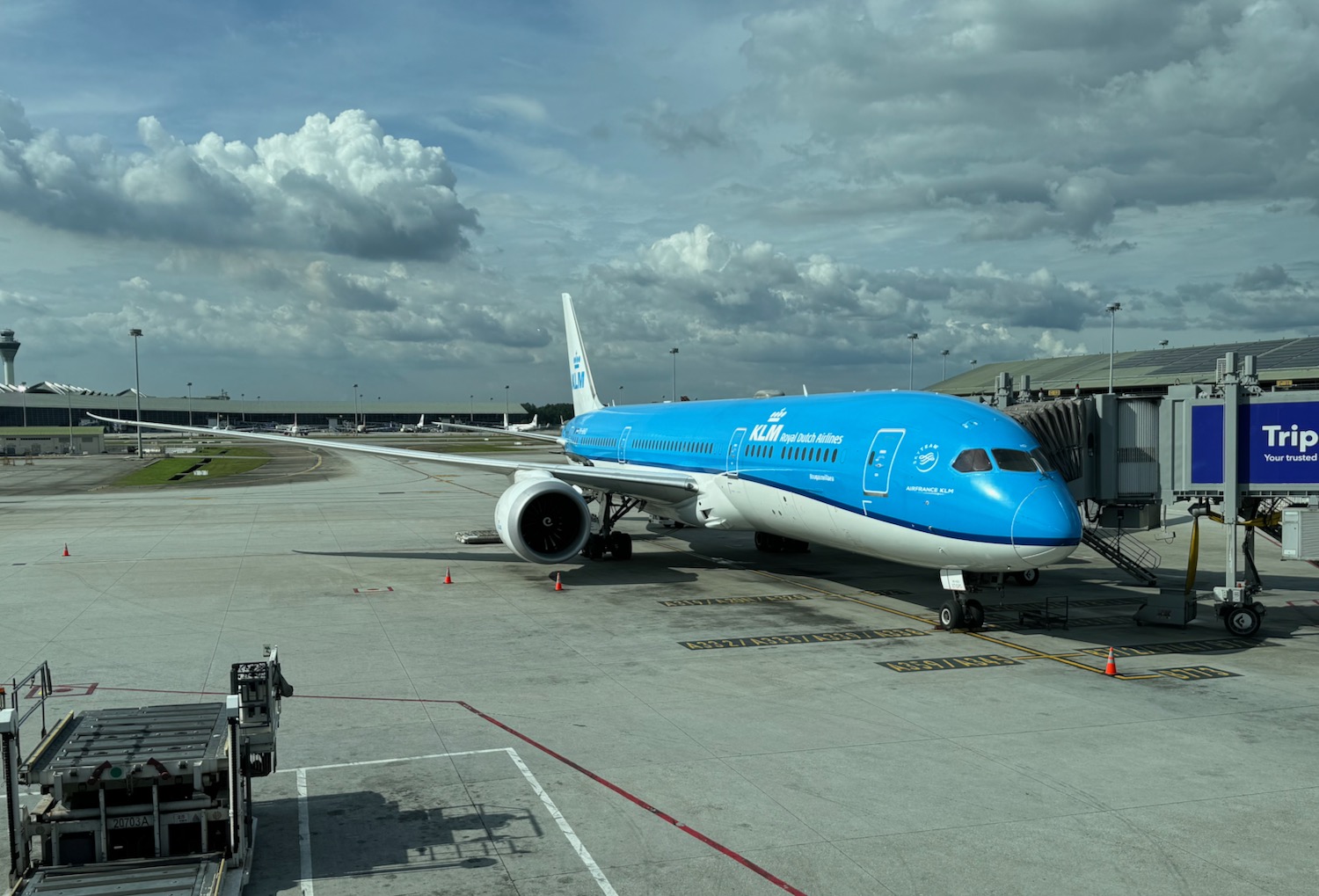 a blue and white airplane on a runway