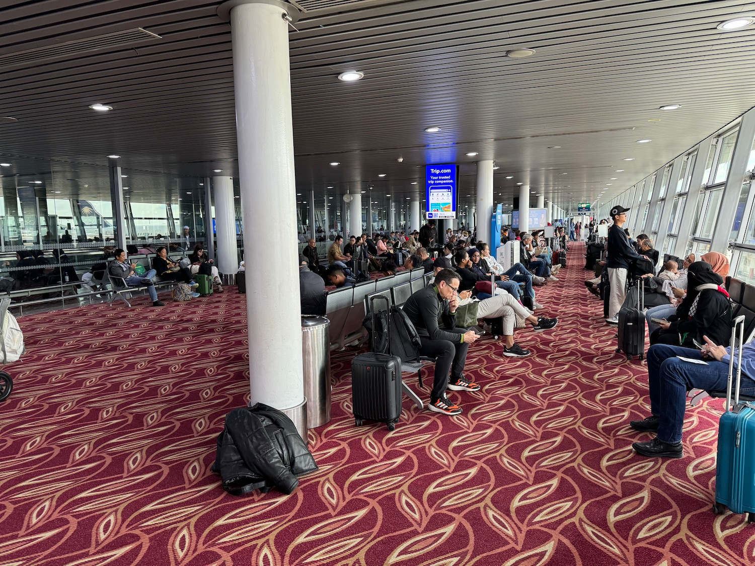 a group of people sitting in an airport terminal