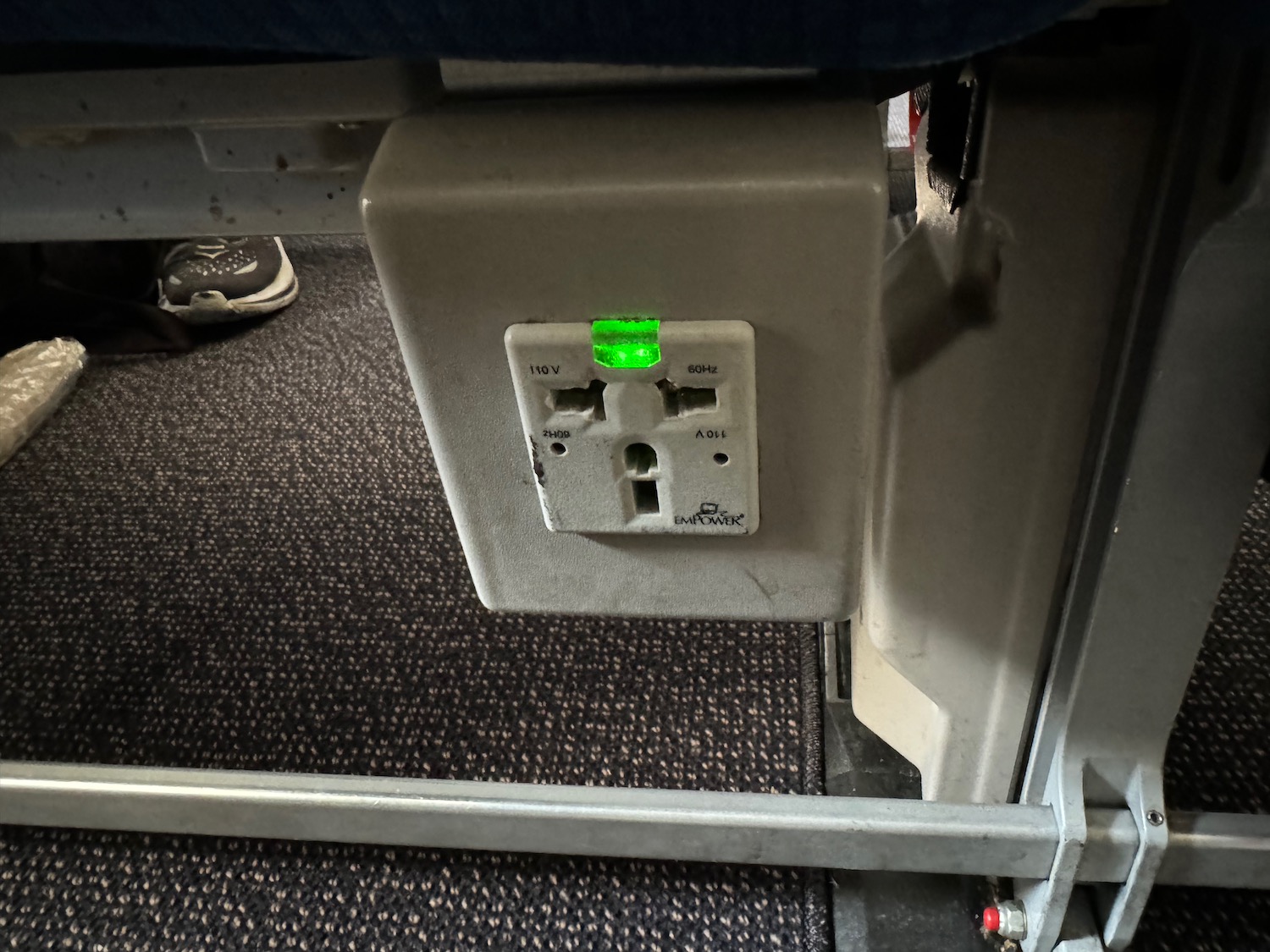 an electrical outlet with a green light