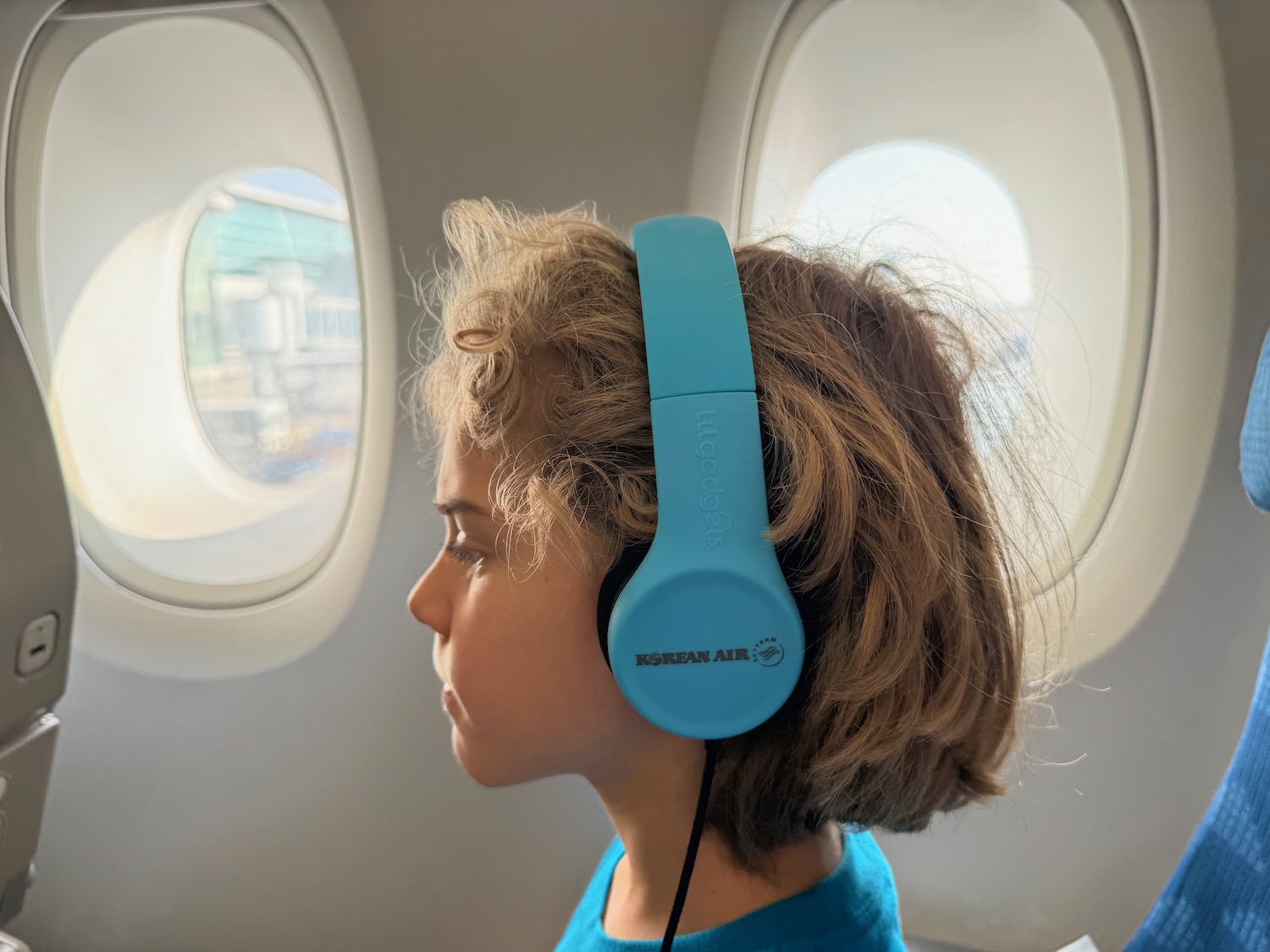 a child wearing headphones in an airplane