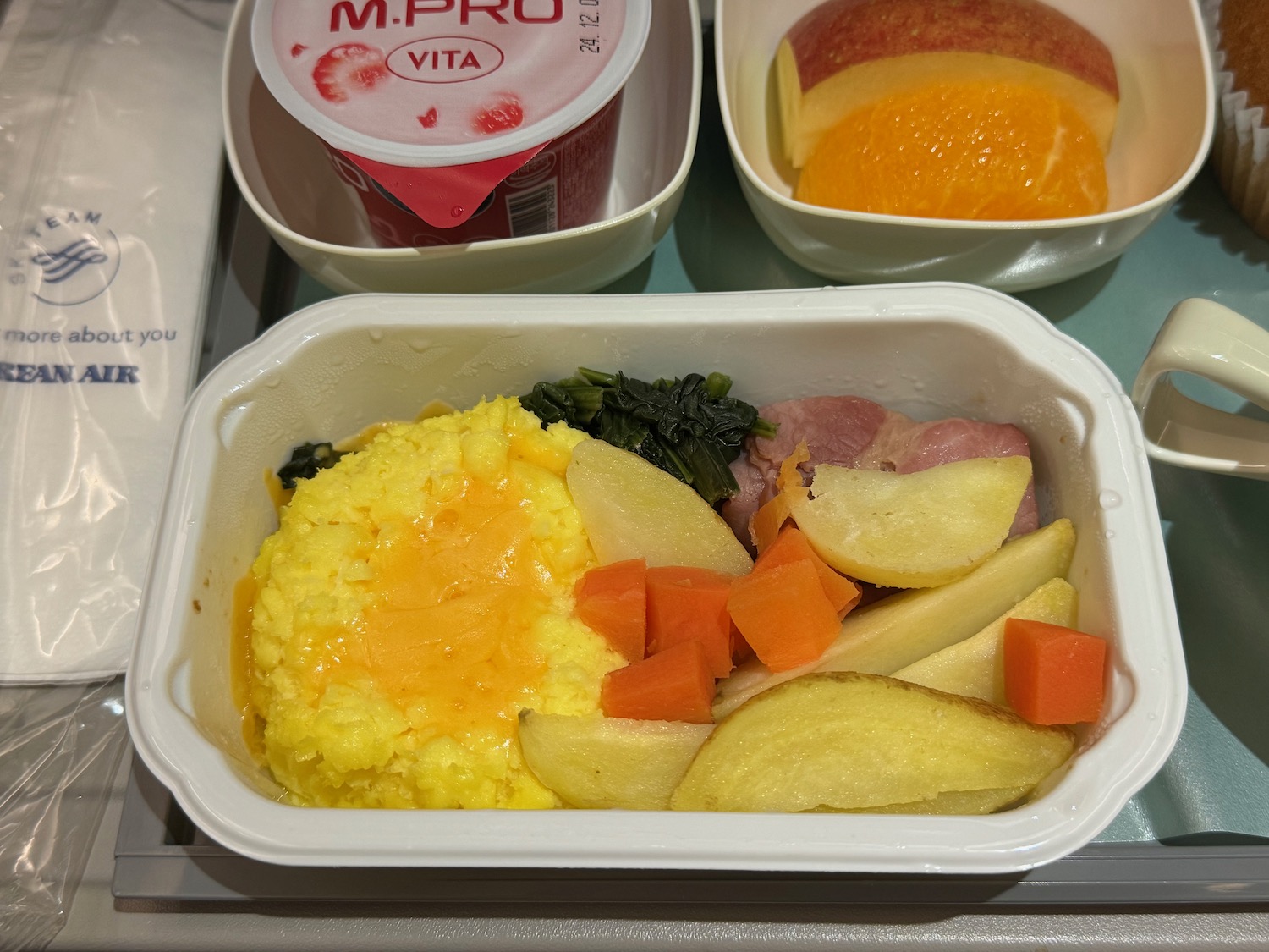 a tray of food with yogurt and fruit