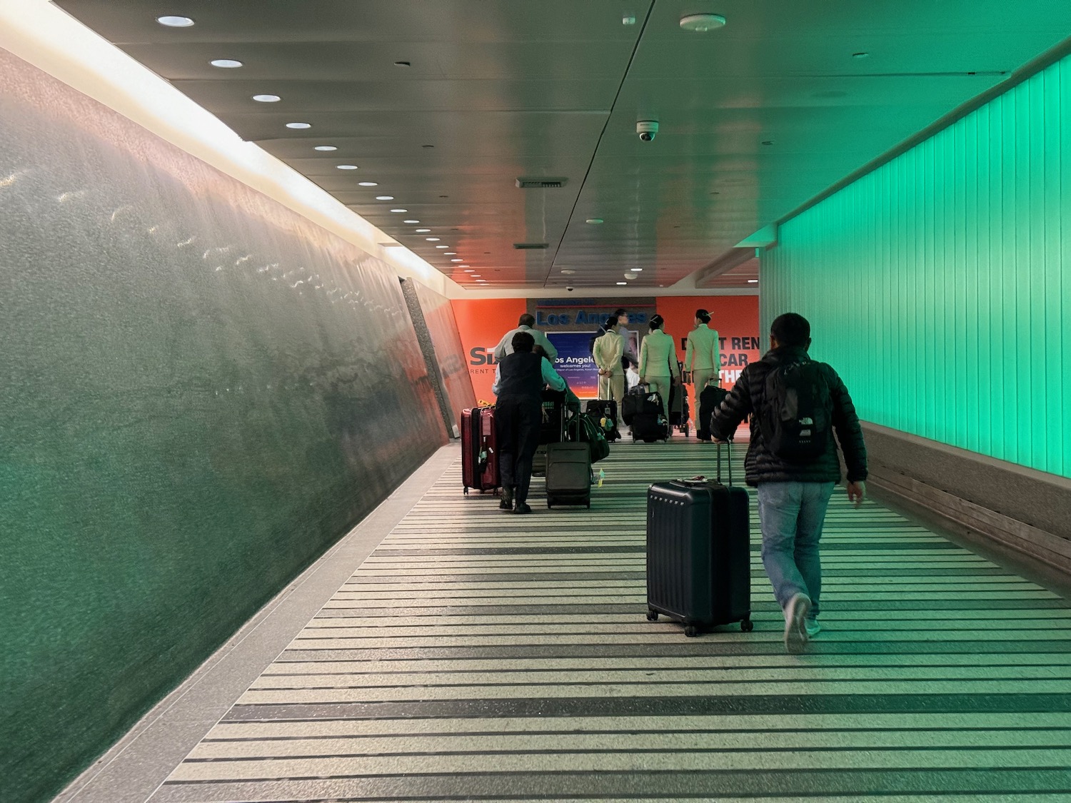 people with luggage in a tunnel