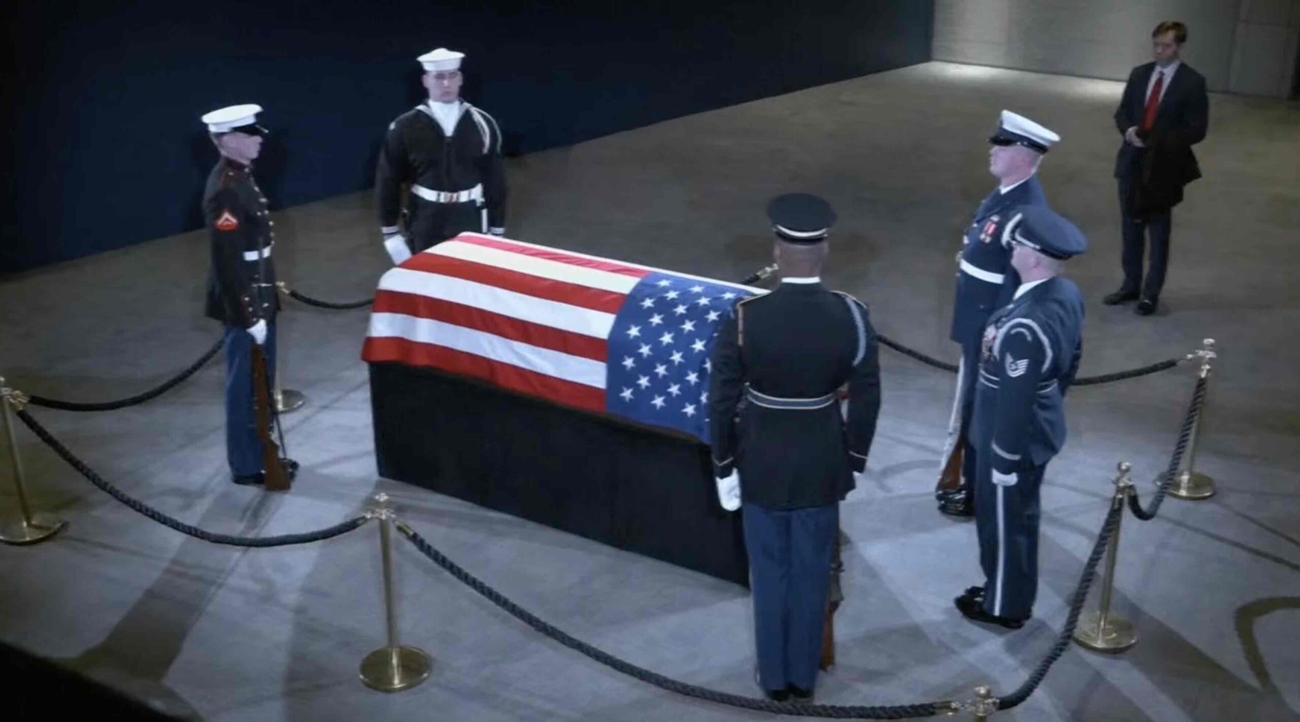 a group of soldiers standing around a casket