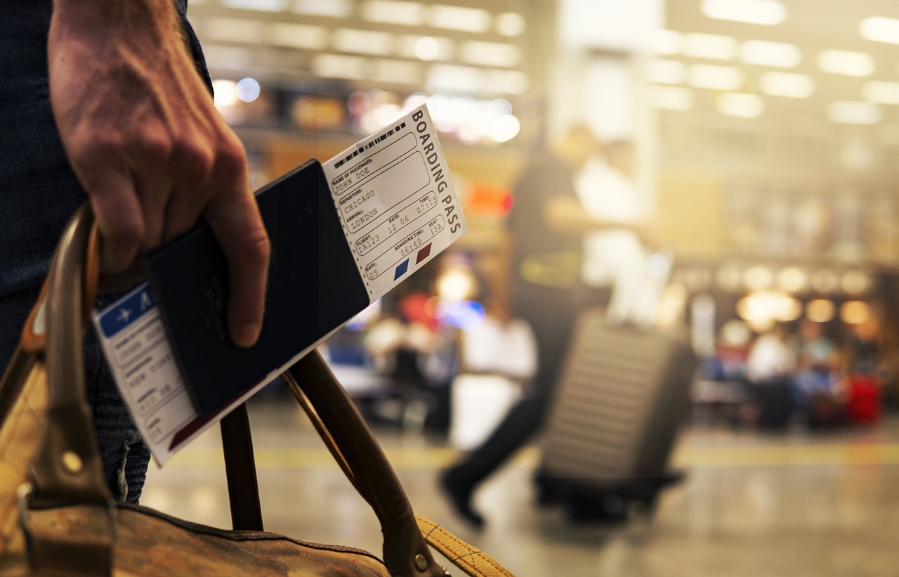 a person holding a passport and boarding pass