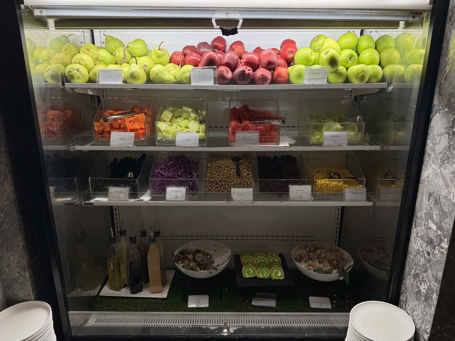 a display case with different fruits and vegetables