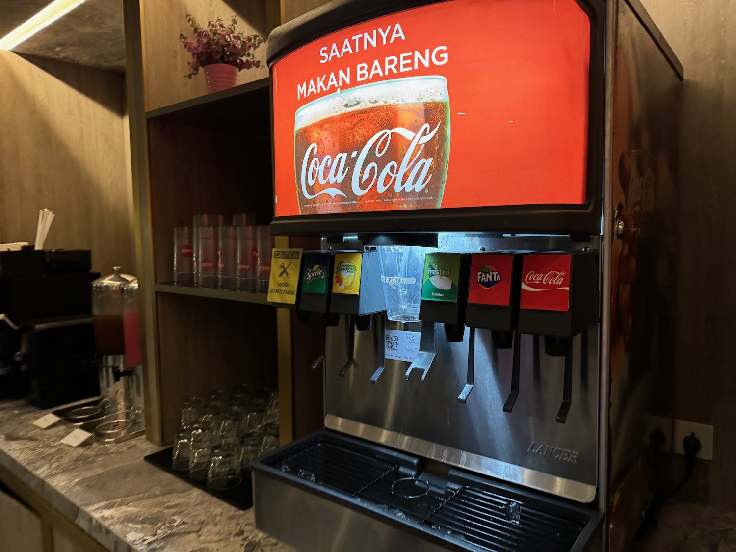 a soda dispenser with a drink dispenser