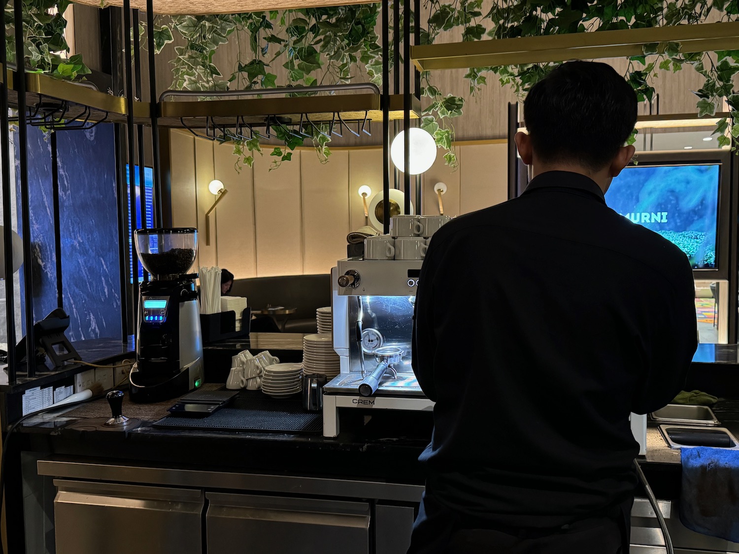 a man standing in front of a coffee machine