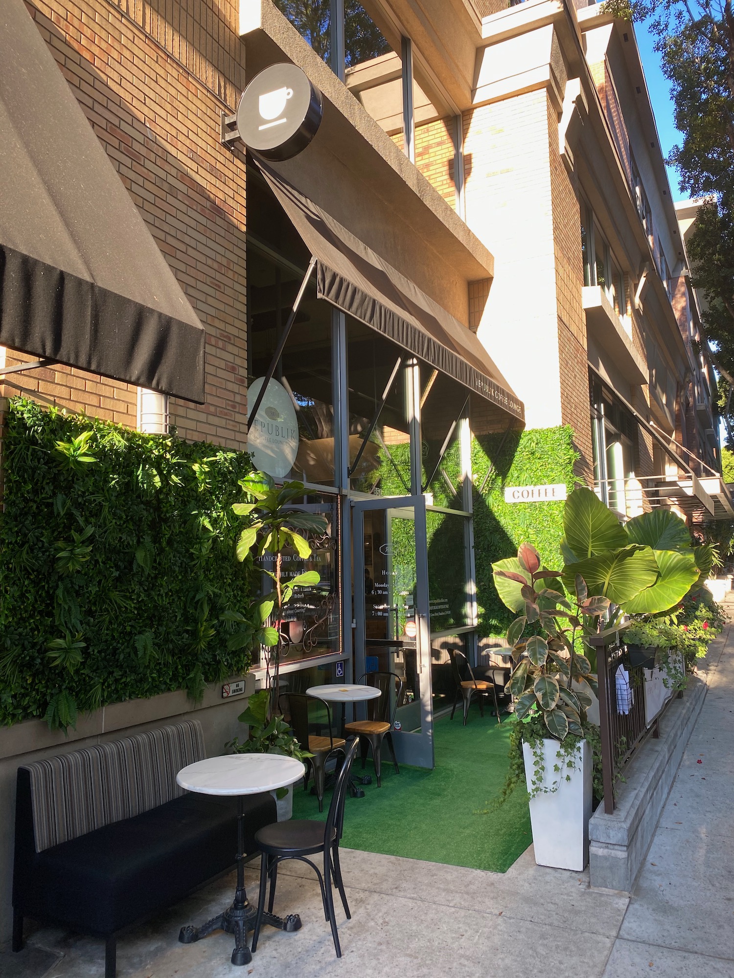 a building with a green wall and plants