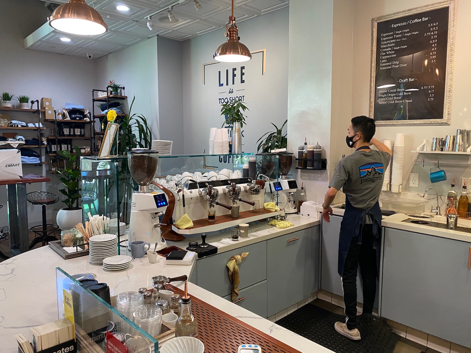 a man standing at a counter in a coffee shop