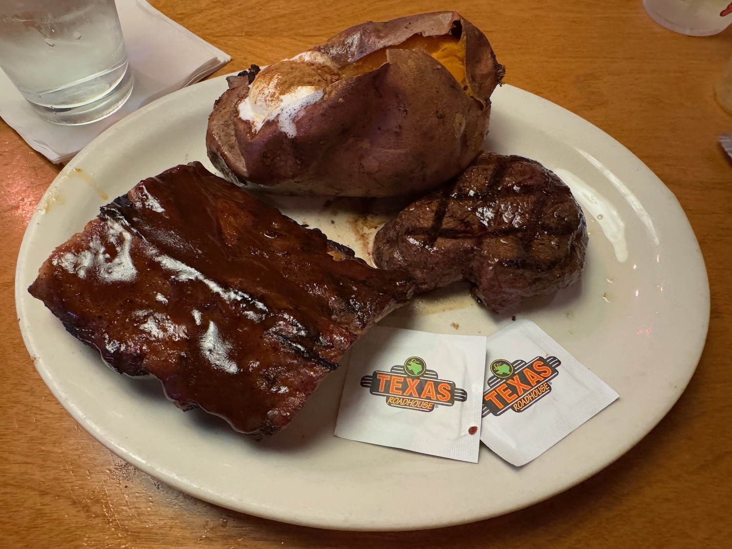 a plate of steak and a baked potato