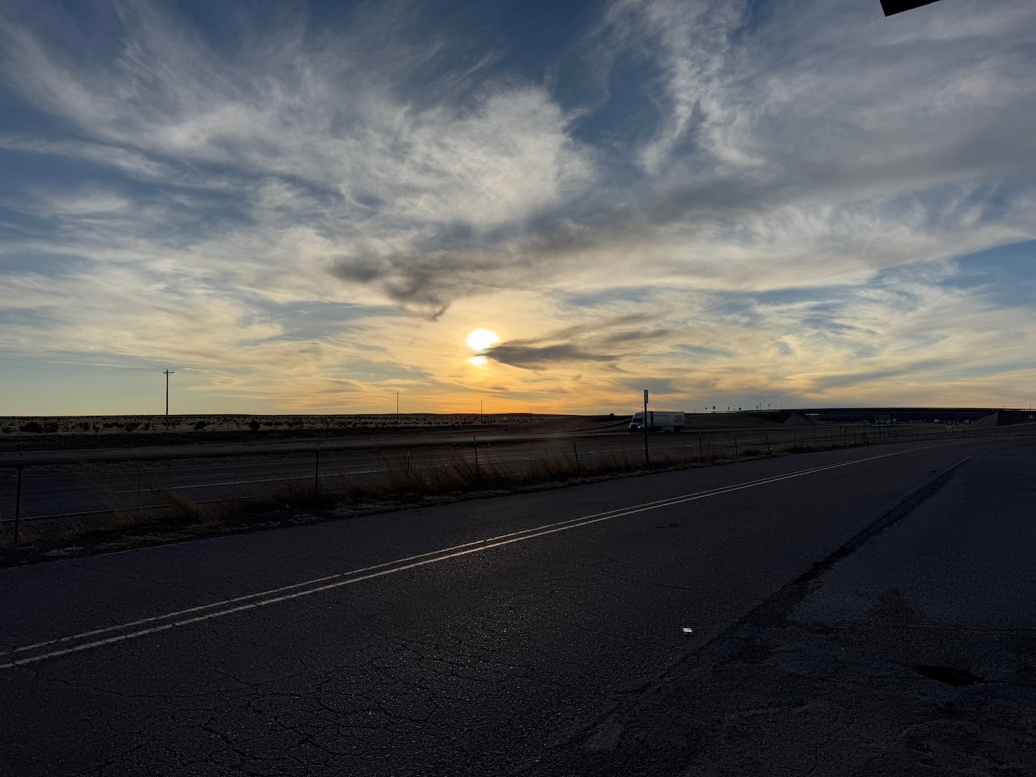 a road with a sunset in the background