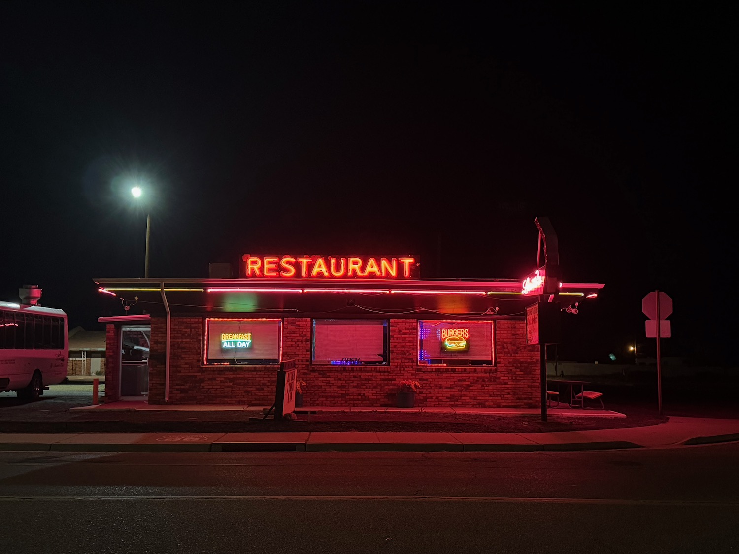 a restaurant with red lights at night