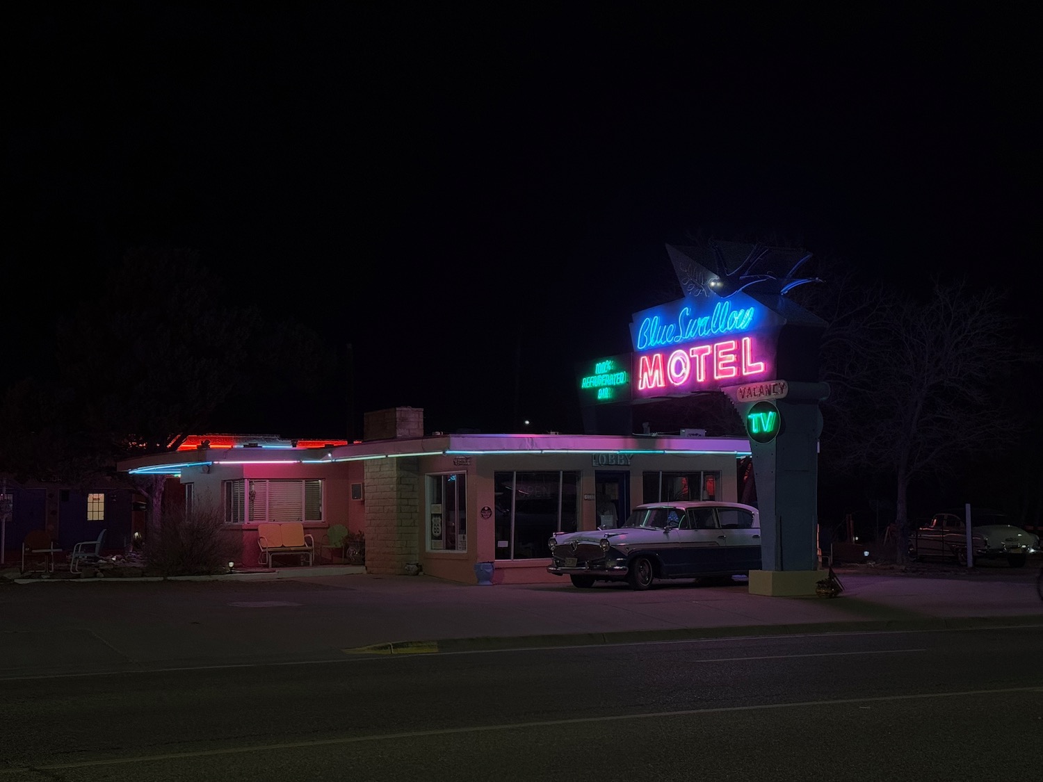 a motel with neon lights at night