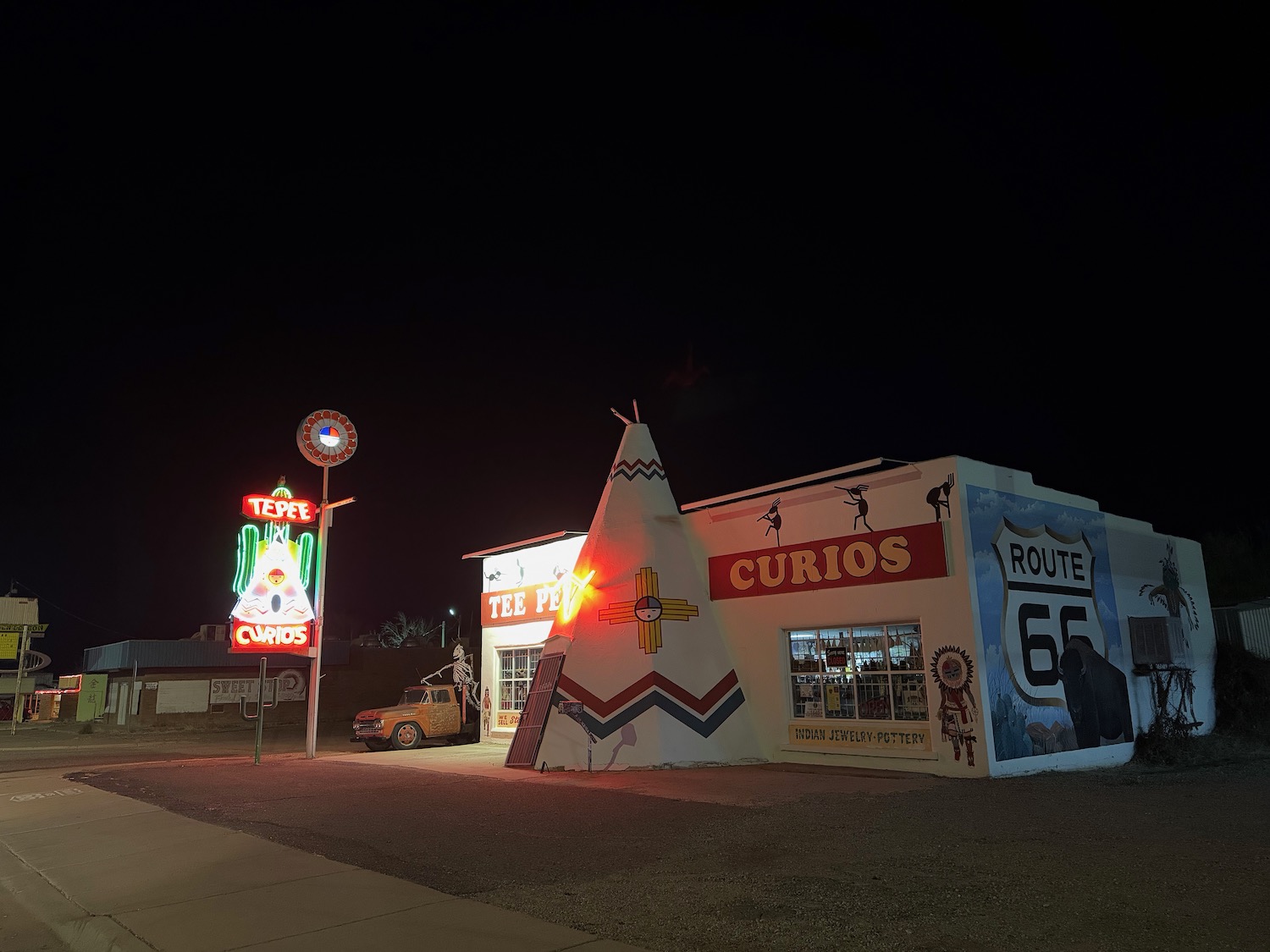 a building with a sign and a car in front of it