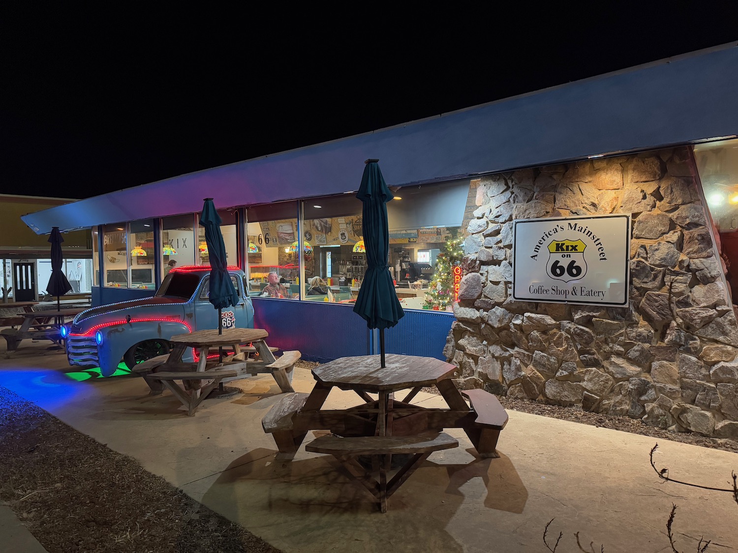 a restaurant with tables and umbrellas