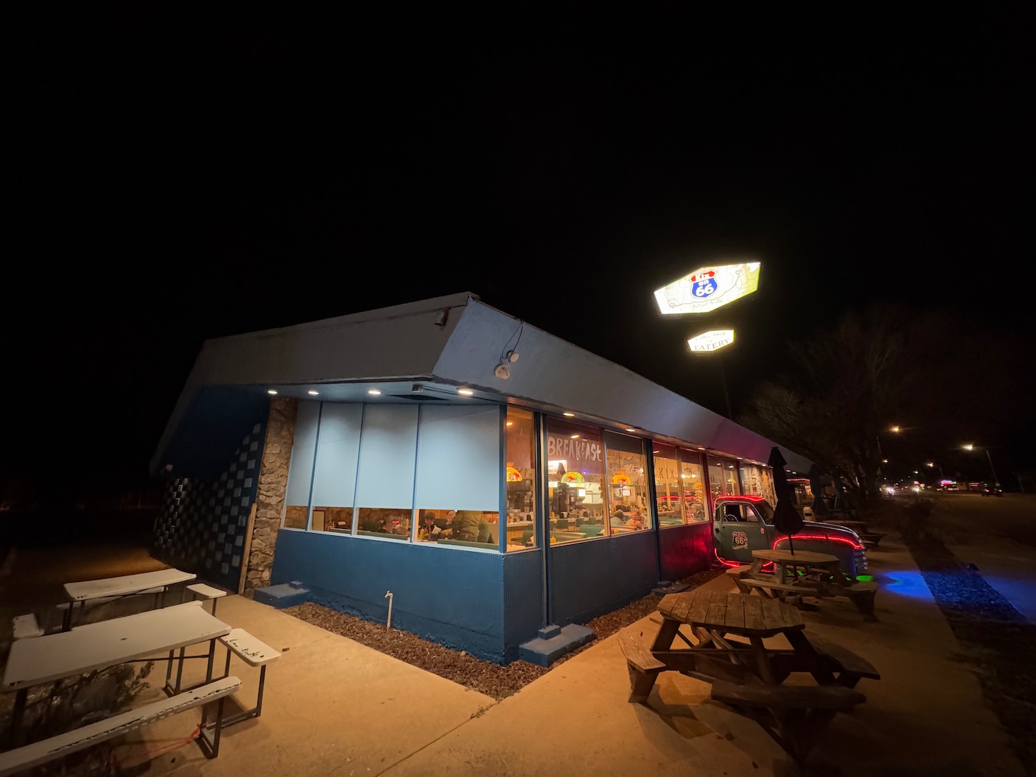 a building with tables and chairs at night