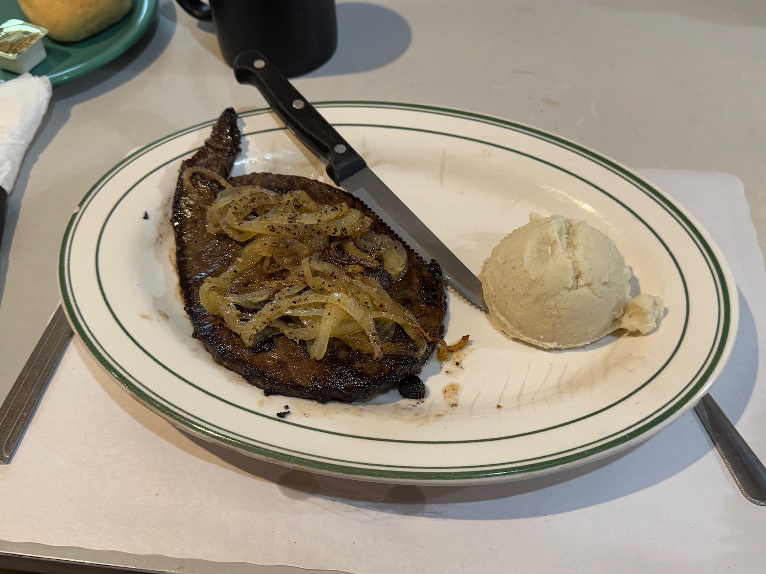 a plate of steak and mashed potatoes