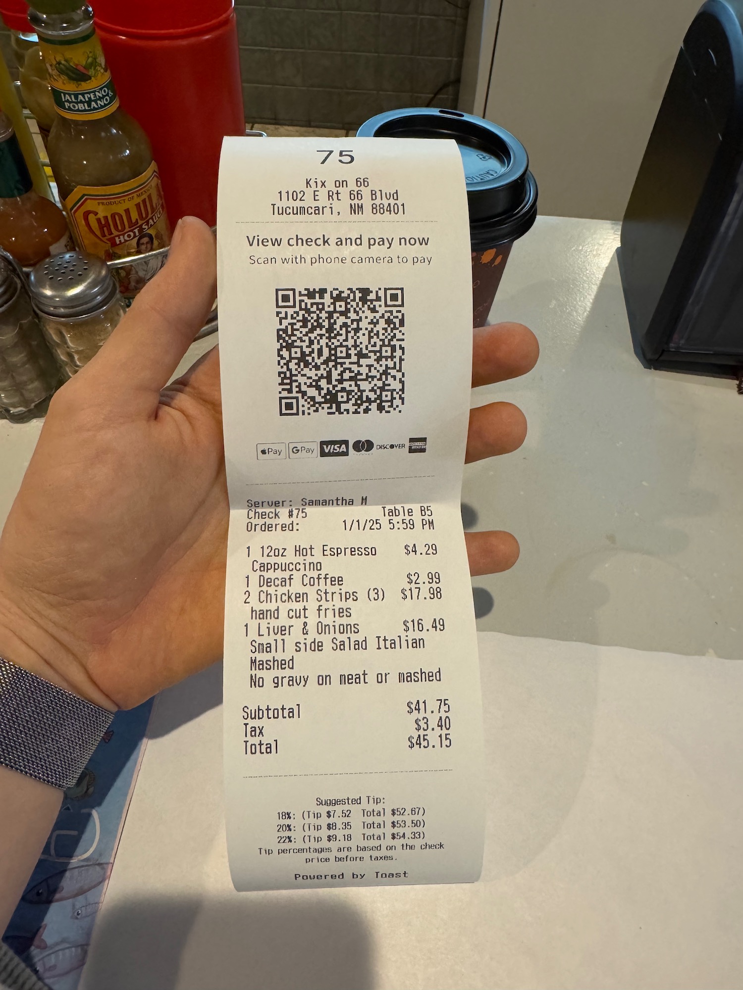 a hand holding a receipt