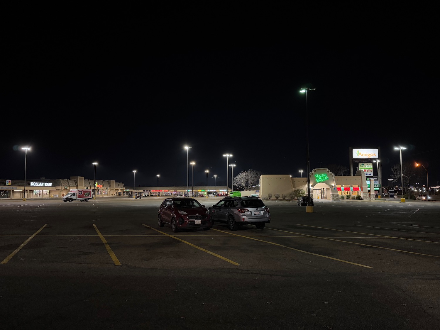 cars parked in a parking lot at night