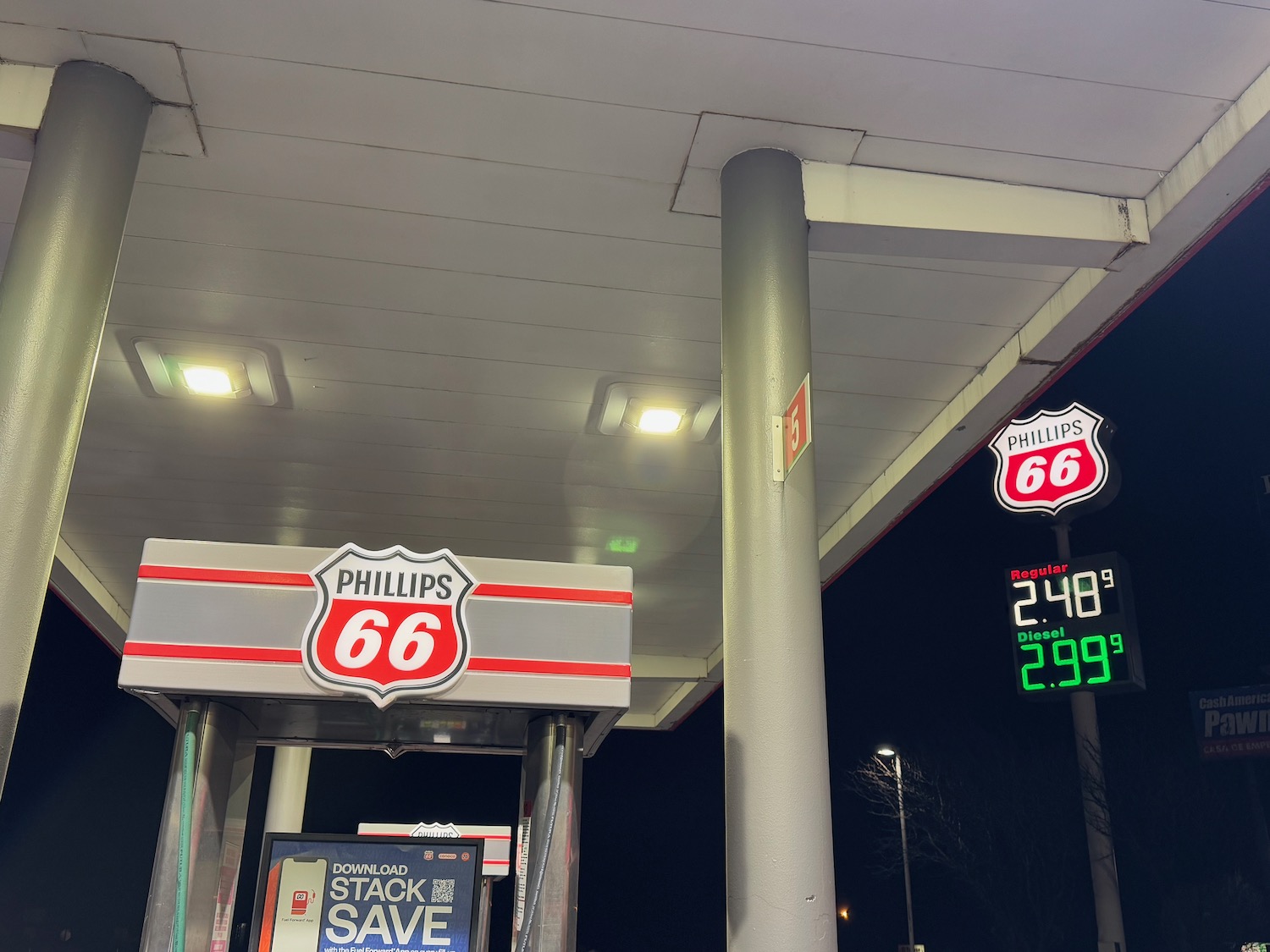 a gas station with signs and numbers