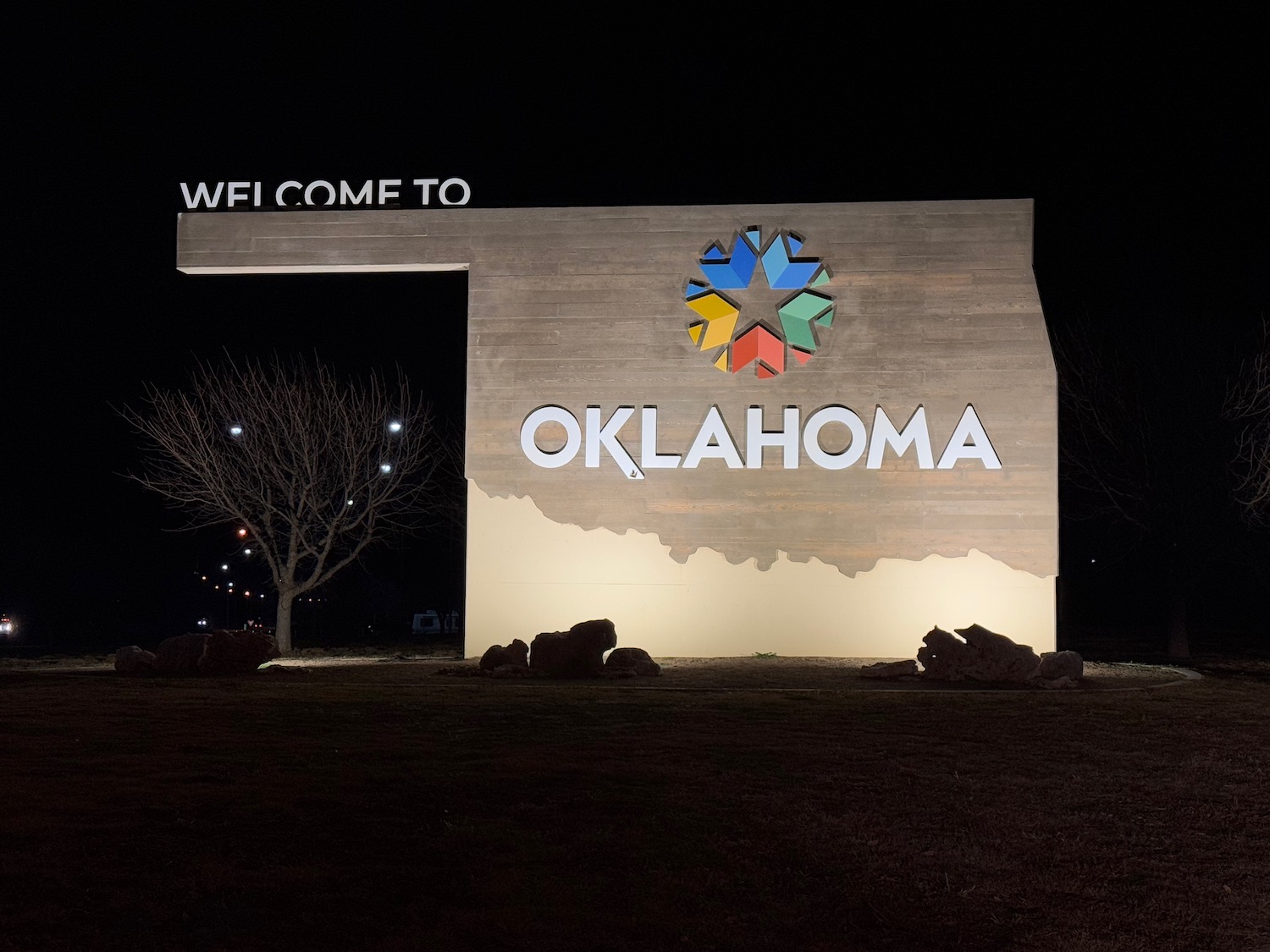 a sign with a large shape and a logo