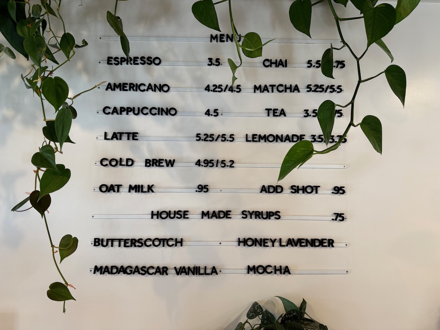 a menu board with green leaves