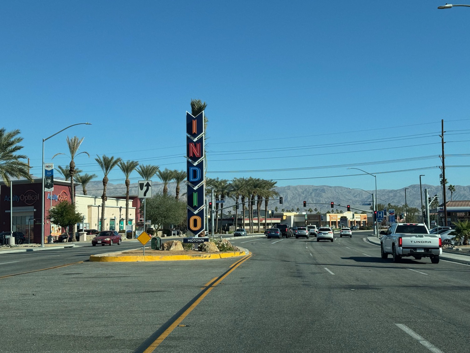 a street with cars and a sign