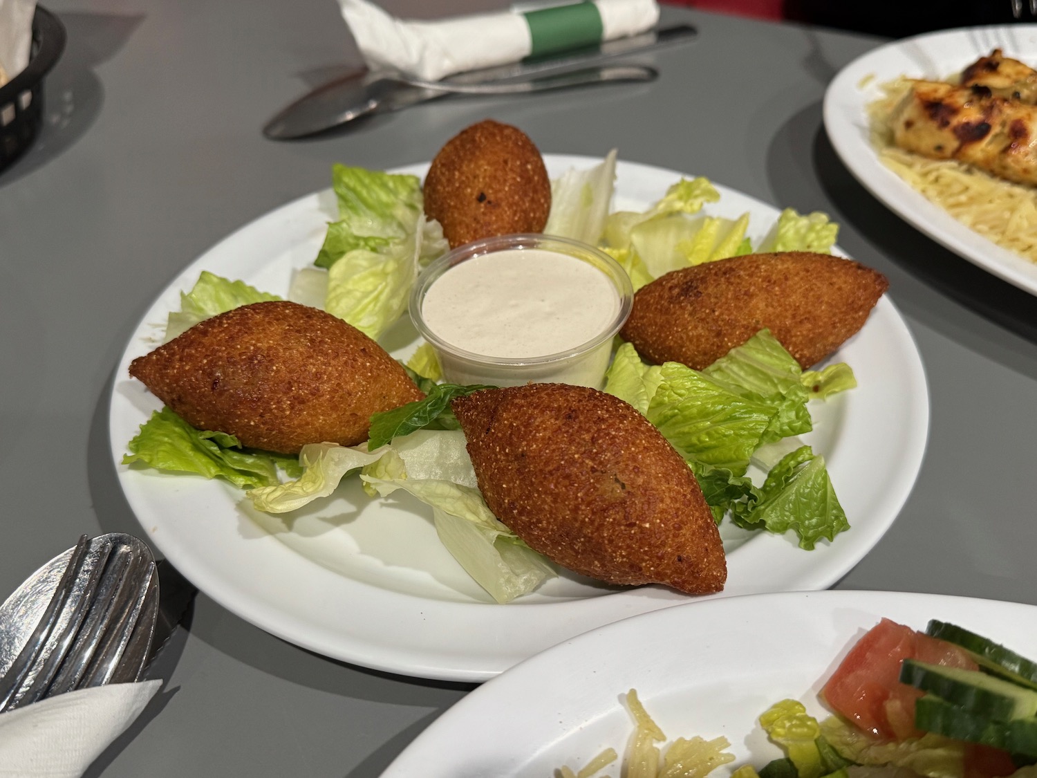 a plate of fried food with sauce on it