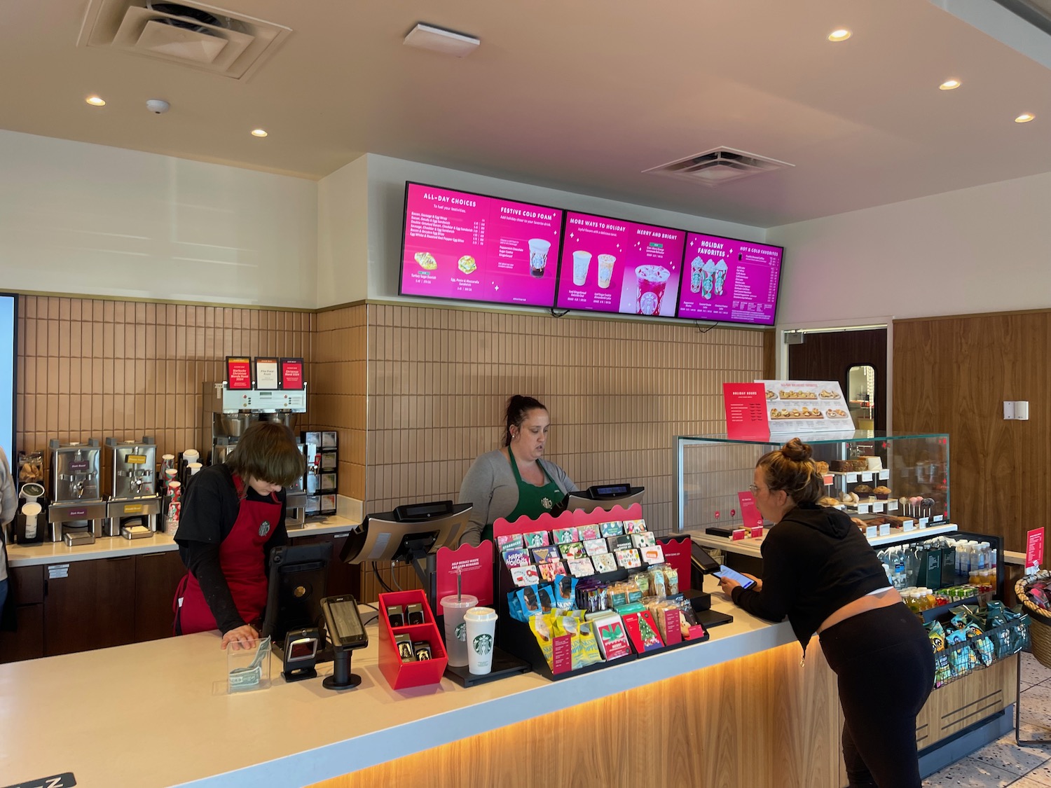 a woman standing at a counter in a fast food restaurant