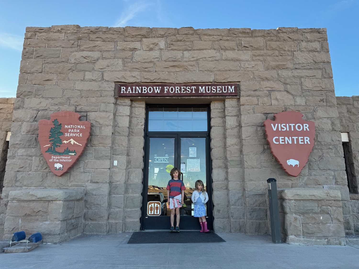 two girls standing in front of a building