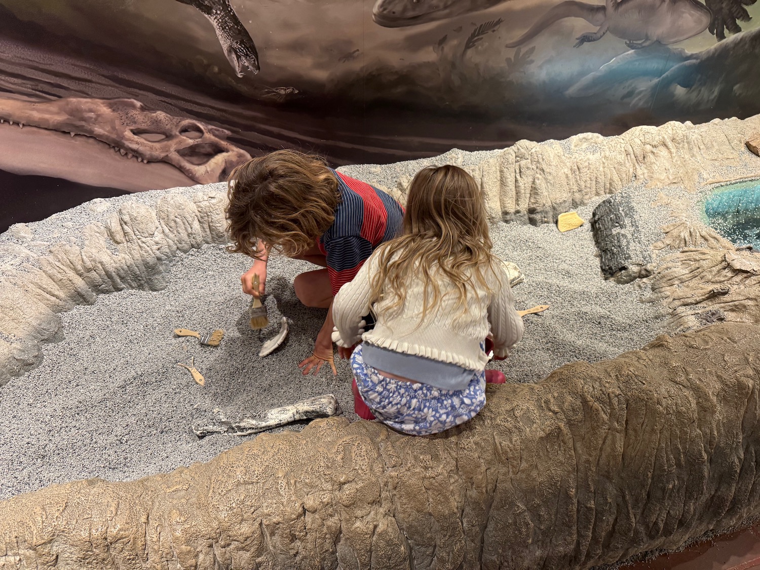 two children playing in a sandbox