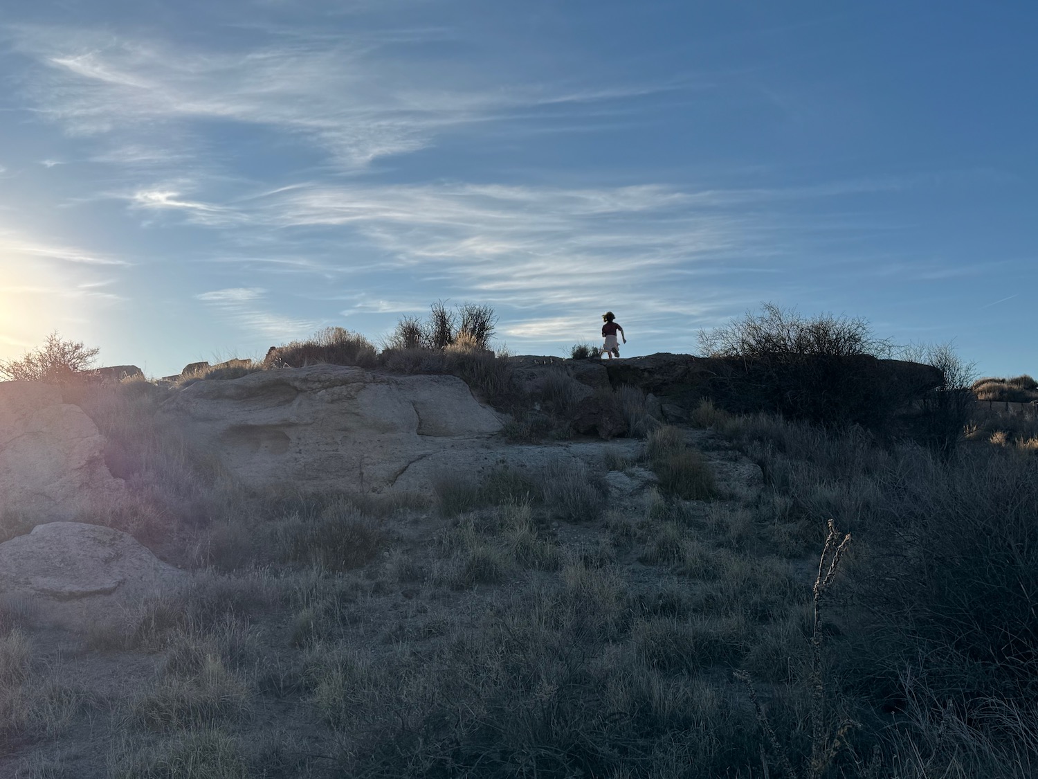 a person walking on a rocky hill